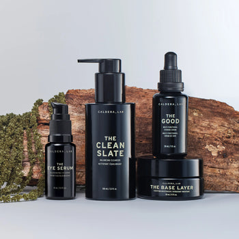 The Regimen + Eye Defense in front of wood and plants