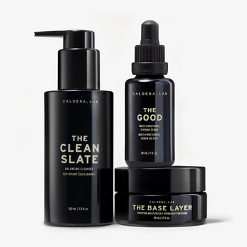 The Regimen by Caldera + Lab features 3 products: The Good Serum, The Clean Slate Cleanser and The Base Layer moisturizer. Photographed in their glass bottles.