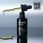Caldera + Lab skincare The Good serum bottle with dropper on a reflective surface, featuring 'Made Safe' certification.
