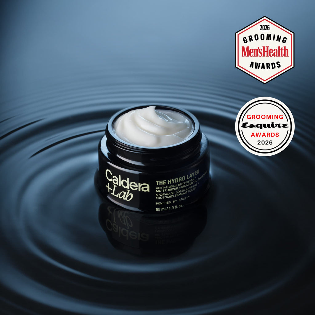 A jar of the hydro layer by Caldera + lab shown on water with the top removed the moisturizer cream visible