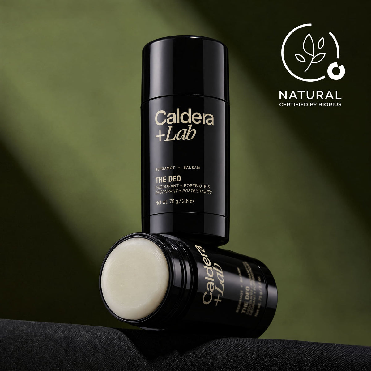 Caldera + Lab The Deo natural gel deodorant showing the off-white gel texture inside, set against a dark olive green background with a 'Natural Certified by Biorius' badge in the top right.